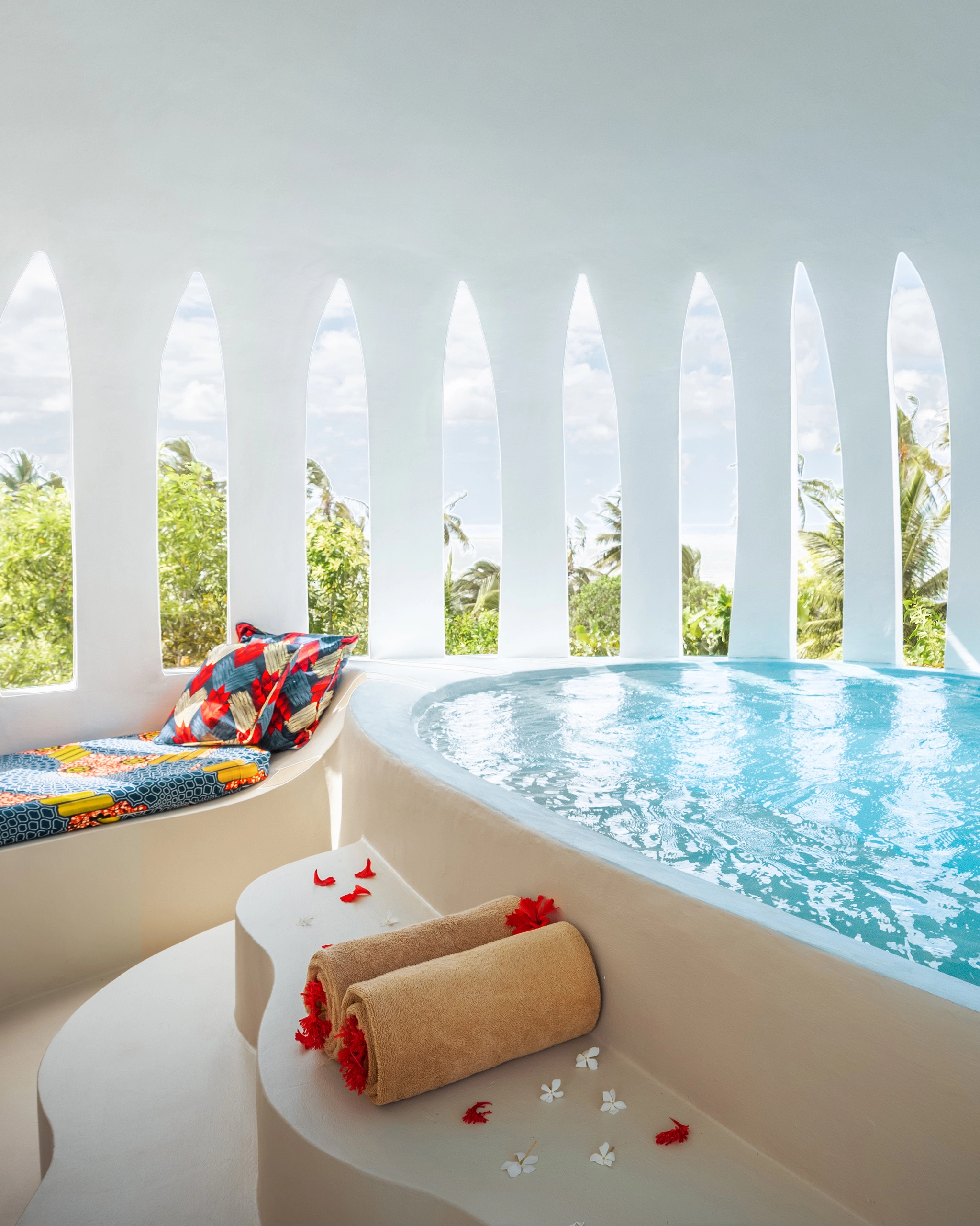 Private villa jacuzzi framed by sculptural white arches
